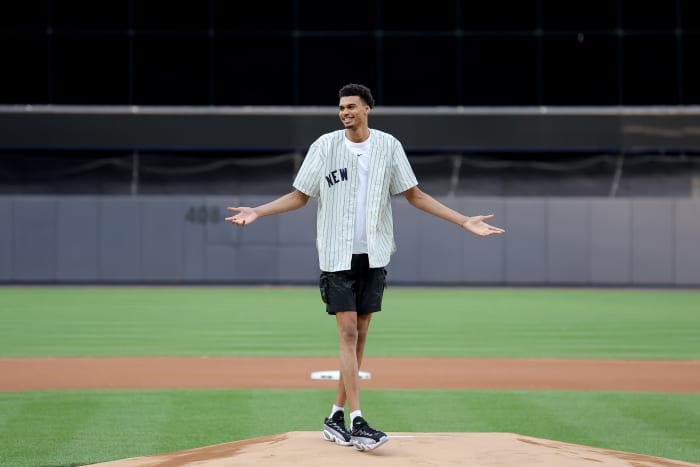Victor Wembanyama reacts after throwing out the first pitch before a New York Yankees game.